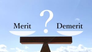 天秤にかけられている「Merit」と「Demerit」の文字